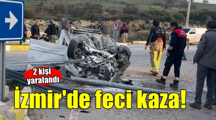 İzmir de devrilen otomobildeki 2 kişi yaralandı