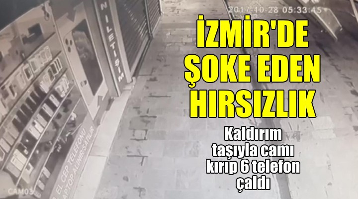 İzmir de şoke eden hırsızlık! Kaldırım taşı ile camı kırıp 6 cep telefonu çaldı!